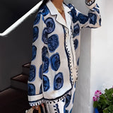 Blue Agate Satin Pajama Set featuring a luxurious design, with a long-sleeved top in a soft blue satin fabric and a matching pair of pants, offering a comfortable and stylish sleepwear option.