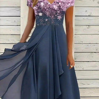 Blue and black floral sequin V-neck knee-length cocktail dress with blue rose pattern, displayed on a mannequin, highlighting the dress's elegant design and shimmering sequin detailing.
