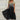 Blue and black floral sequin V-neck knee-length cocktail dress in black gold color shown on a model, emphasizing the elegant design and intricate detailing.