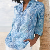 Blue Floral Boho Chic Women's Blouse in a size 2XL, featuring elegant blue and white floral patterns, short sleeves, a delicate neckline, and a relaxed fit perfect for a summer fashion look.