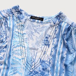 Blue floral boho chic women's blouse with elegant summer design, featuring short sleeves and a stylish pattern suitable for casual or semi-formal occasions.