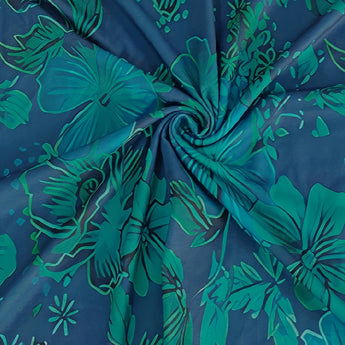 Women's casual knee-length summer dress featuring a blue tropical floral pattern with various shades of azure and aqua, showcasing leafy botanical and flowering plant designs.