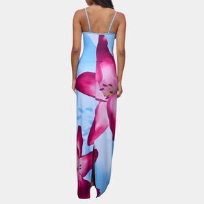Blue floral maxi dress with spaghetti straps, designed as beachwear for summer, showcasing an elegant and vibrant floral pattern in shades of electric blue and violet, highlighting a fitted waist and flowing silhouette.