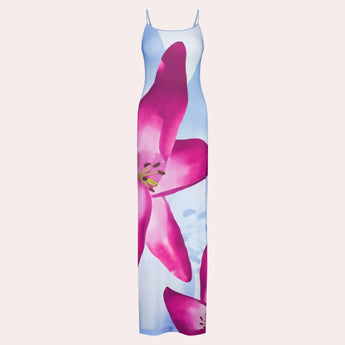 Blue floral maxi dress with spaghetti straps, designed as beachwear summer gown, featuring a flowing silhouette and vibrant floral pattern on soft fabric.