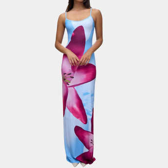 A woman wearing a blue floral maxi dress with spaghetti straps, designed as beachwear for summer. The dress is a 3XL size and features a flowing gown style that reaches the thighs, showcasing a fashionable and elegant look.