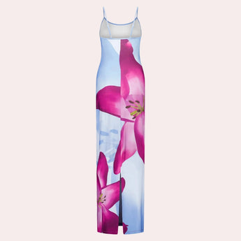 Blue floral maxi dress with spaghetti straps, ideal for beachwear during summer, featuring a flowing design and vibrant floral pattern.
