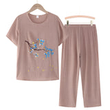 Woman's Khaki Blue Linen Top with Floral Embroidery, 4XL, hanging on a clothes hanger.