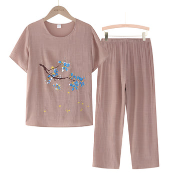 Woman's Khaki Blue Linen Top with Floral Embroidery, 4XL, hanging on a clothes hanger.
