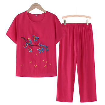 A red 4XL women's casual summer pants set featuring a blue linen top with floral embroidery, long sleeves, and a round neckline.