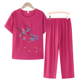 Women's dark pink floral embroidery blouse and pants set, featuring a sleeveless top with a V-neck collar and casual summer design.