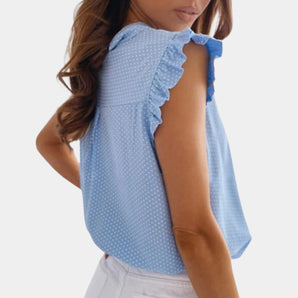 Blue polka dot women's summer top with ruffle sleeves, showcasing a lightweight jersey fabric.