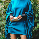 Blue satin mini dress featuring elegant draped cape sleeves, showcasing luxurious women's cocktail wear design.