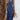 A woman wearing a blue sleeveless maxi dress with adjustable straps, suitable for casual summer wear. The dress features a fitted waist and a flowing skirt, perfect for warm weather.