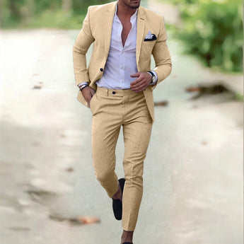 Man wearing a blue slim fit men's suit featuring a modern tailored business casual blazer over a dress shirt with a collar, standing in a stylish pose.