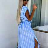 Blue striped sleeveless wrap dress worn by a woman smiling with sunglasses, showcasing a casual summer beachwear style.