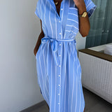 Blue striped sleeveless wrap dress designed for casual summer beachwear, featuring a V-neckline and a flattering fit, suitable for a relaxed outing.