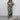 Elegant dark green tropical leaf print maxi dress with a flattering V-neckline, designed for summer wear. The dress features long sleeves and a fitted waist, with a stylish pattern that adds to its fashionable appeal.
