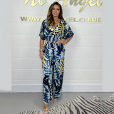 Blue tropical leaf print maxi dress with an elegant V-neck design, featuring a dark blue color and tailored for a 4XL size. The dress showcases a stylish one-piece garment suitable for formal occasions, reaching from the knee to thigh length.