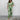Elegant V-neck summer maxi dress featuring a blue tropical leaf print pattern on a light green fabric, designed with sleeves and a fitted waist, suitable for formal and casual occasions.