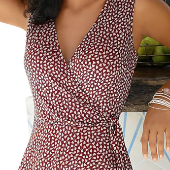 Woman wearing a blue and white geometric V-neck sleeveless A-line summer dress, highlighting the fashion-forward design and comfortable fit.