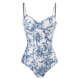 Blue and white one-piece swimsuit with a tropical palm leaf design, featuring an artistic pattern and vibrant electric blue accents.