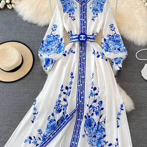 Blue and white floral print long sleeve dress with belt and collar.