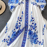 Blue and white long sleeve dress with floral porcelain print and waist belt.