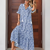 Woman wearing a blue and white V-neck boho maxi dress, perfect for lightweight summer beachwear, standing outdoors with sunglasses.