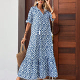 Woman wearing a blue and white V-neck boho maxi dress ideal for lightweight summer beachwear, paired with sunglasses.