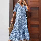 Woman wearing a blue and white v-neck boho maxi dress with a lightweight, flowy design, suitable for summer beachwear.