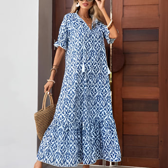 Woman wearing a blue and white v-neck boho maxi dress with a lightweight, flowy design, suitable for summer beachwear.