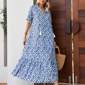 Blue and white V-neck boho maxi dress, lightweight summer beachwear, featuring short sleeves and cinched waist.