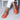Blush Pink Low Heel Ballet Flats in orange, shown on a woman's feet while standing, highlighting the minimalist design and comfort.