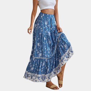 Bohemian Blue Floral Maxi Skirt in a lightweight fabric, ideal for summer beachwear, shown in size XL. The skirt features a flowing design with a vibrant floral pattern, modeled outdoors to highlight its casual and breezy style.