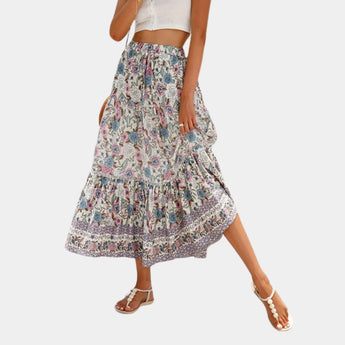 
A Bohemian Blue Floral Maxi Skirt in lightweight fabric, suitable for summer beachwear, displayed in a Beige color and XL size, with a focus on its flowing design.