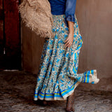 Bohemian blue floral wrap skirt with an asymmetric high-low hem, featuring a vibrant azure color and intricate floral patterns, perfect for a breezy summer day.