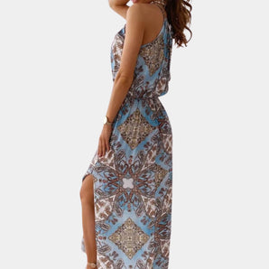 Bohemian Blue Paisley Sleeveless Maxi Dress with an elegant high slit, featuring a paisley pattern and a flattering silhouette, highlighting the shoulders and waist.