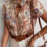 Bohemian Chic Paisley Silk Blouse featuring a vintage-inspired design with a high collar, long sleeves, and intricate paisley pattern in a soft, flowing silk fabric.