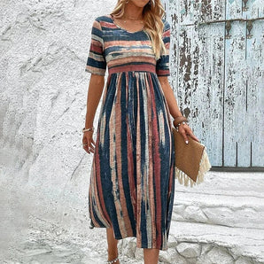 Woman wearing a blue XXL Bohemian Chic Striped Midi Dress with short sleeves and a fitted waist, showcasing casual summer fashion.