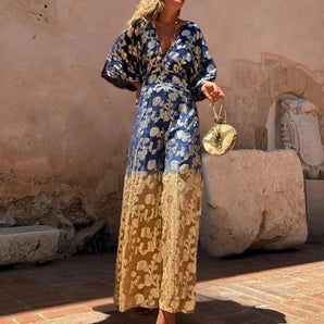 Bohemian Chic V-Neck Maxi Dress in blue and gold floral pattern, featuring long sleeves and a flowing silhouette, perfect for formal or casual wear.