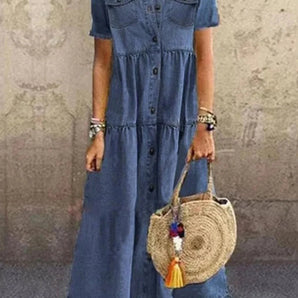 Bohemian dark blue denim maxi dress with short sleeves and pockets, featuring a fashionable summer style ideal for casual outings.