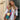 Bohemian embroidered patchwork dress featuring intricate designs, showcased on a model smiling with visible shoulders and neck, highlighting the dress's pink tones and fashion-forward collar and sleeves, perfect for summer artisan fashion.