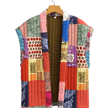 Bohemian embroidered patchwork dress featuring a vibrant mix of magenta and other colors, displayed on a clothes hanger. The dress has a distinct collar, creative arts-inspired design, and long sleeves, embodying artisan summer fashion.