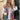 Bohemian embroidered patchwork dress featuring a colorful and intricate design, worn by a model accessorized with sunglasses, highlighting the dress's white and multicolored textile, short sleeves, and unique neckline.