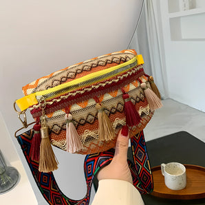 Bohemian ethnic crossbody bag featuring a colorful tribal pattern with tassels, predominantly in shades of yellow.