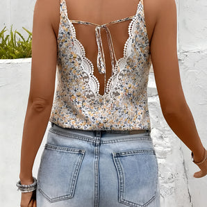 White bohemian floral lace tank top featuring a tassel tie back, displayed on a mannequin, highlighting its sleeveless design and intricate lace details suitable for women's summer fashion.