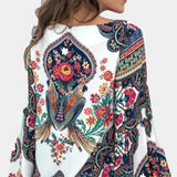 
Women's ethnic blouse with a bohemian floral paisley design, featuring long sleeves and a collar, predominantly white in color.