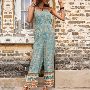 Bohemian floral wide-leg jumpsuit for women, featuring a purple and azure floral pattern, with short sleeves and a comfortable, loose fit ideal for summer beach outings. 