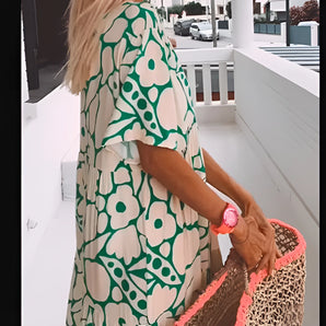 Bohemian oversized summer dress in green with a floral pattern, featuring flowy design suitable for beach wear. The dress has a comfortable fit with details on the shoulder, neck, sleeve, and waist areas, available in size 3XL.