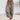 Loose-fit Bohemian ink splash harem pants in persimmon color, size 3XL, featuring a vibrant motif. The trousers are styled for yoga with a relaxed waist and thigh fit, emphasizing comfort and flexibility.